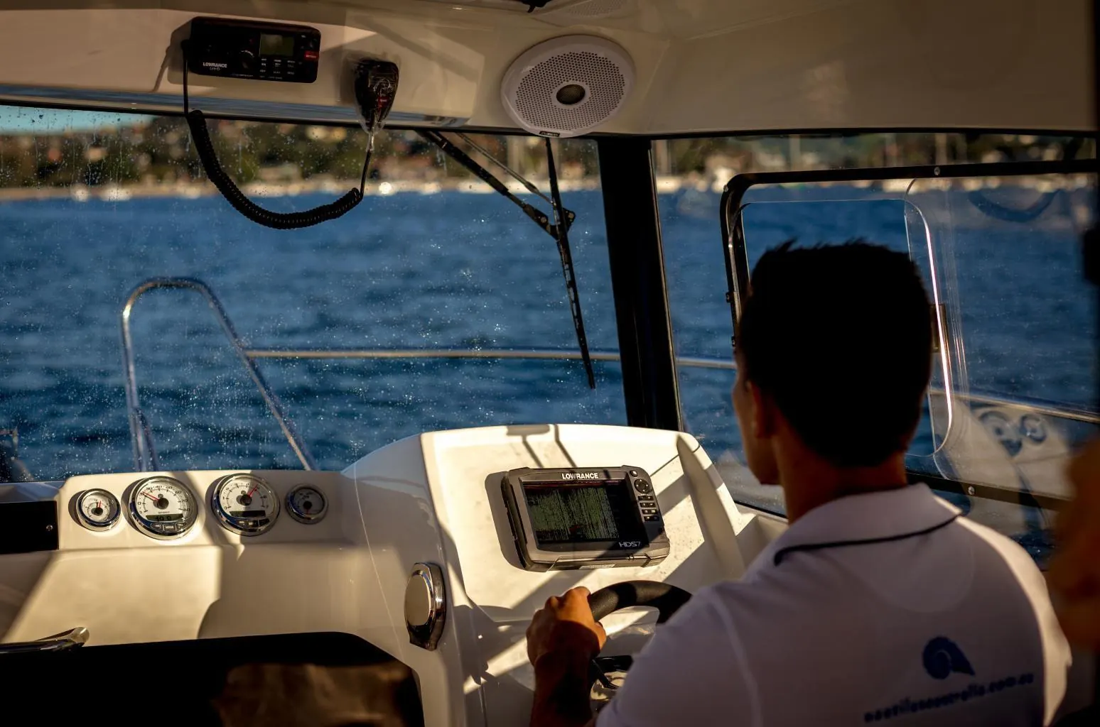 Captain at the helm of a small vessel